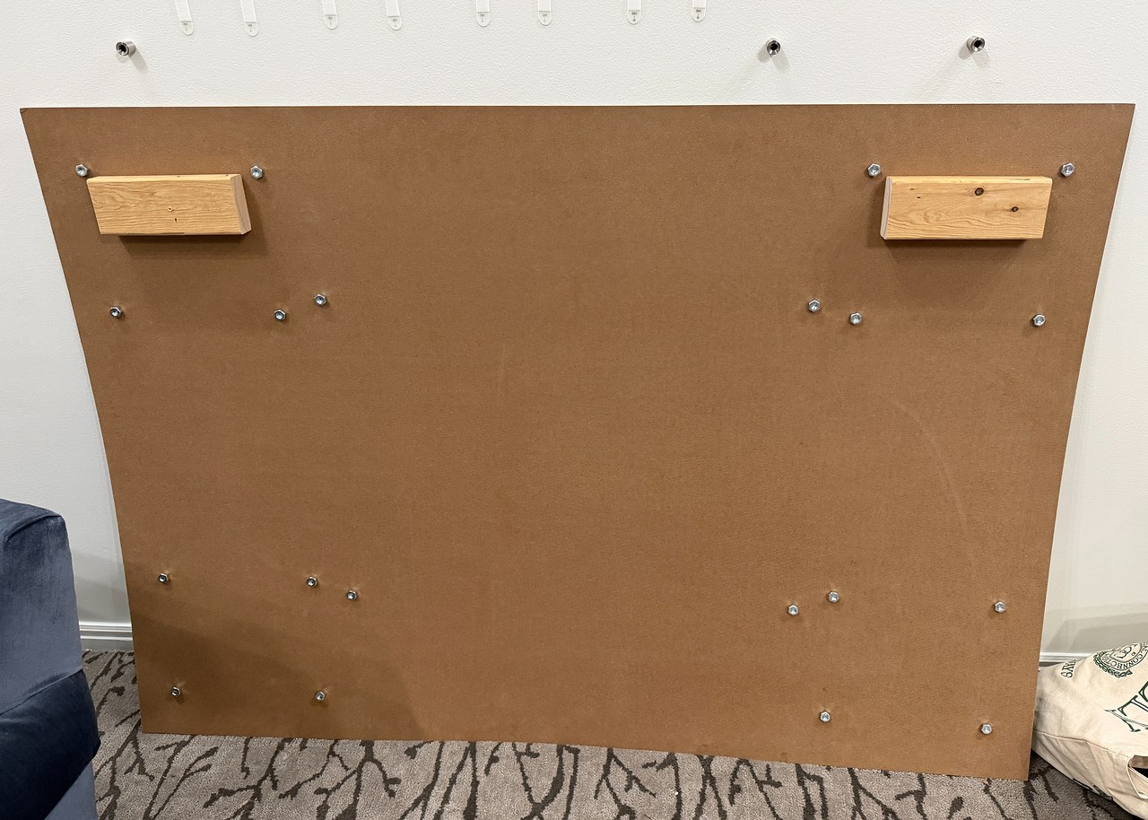 Back of portable gallery board showing mounting bolts and wood supports