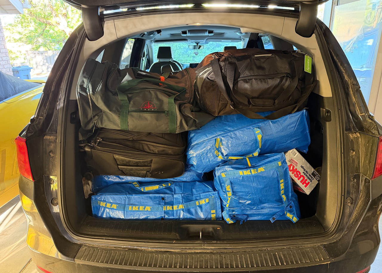 SUV packed with organized Havasupai camping gear, including IKEA bags, luggage, and duffels separated into hotel, camp, and travel systems before the trip.