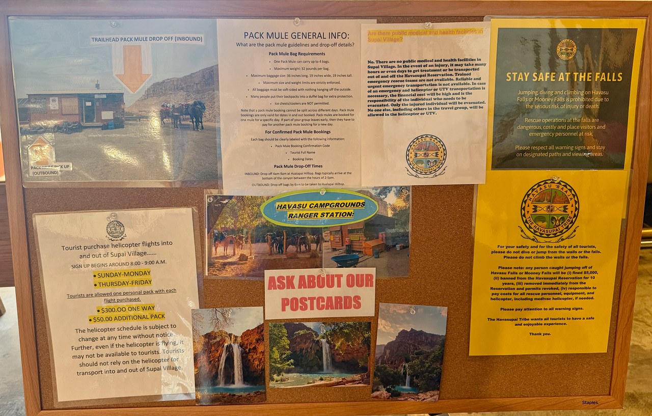 Bulletin board at Grand Canyon Caverns Inn with up-to-date Havasupai permit pickup, pack mule, helicopter, and safety information.