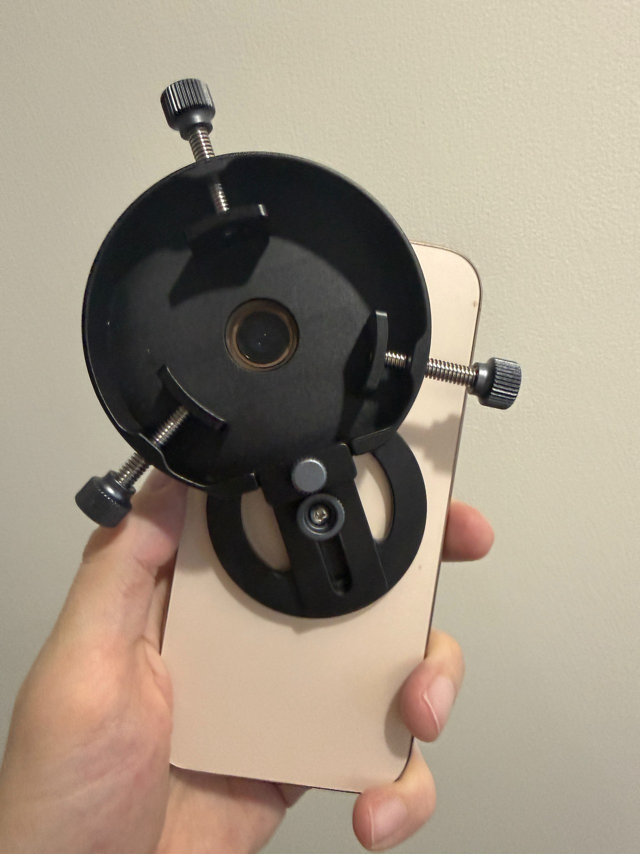 MagSafe spotting scope phone adapter attached to a phone and aligned with a spotting scope eyepiece
