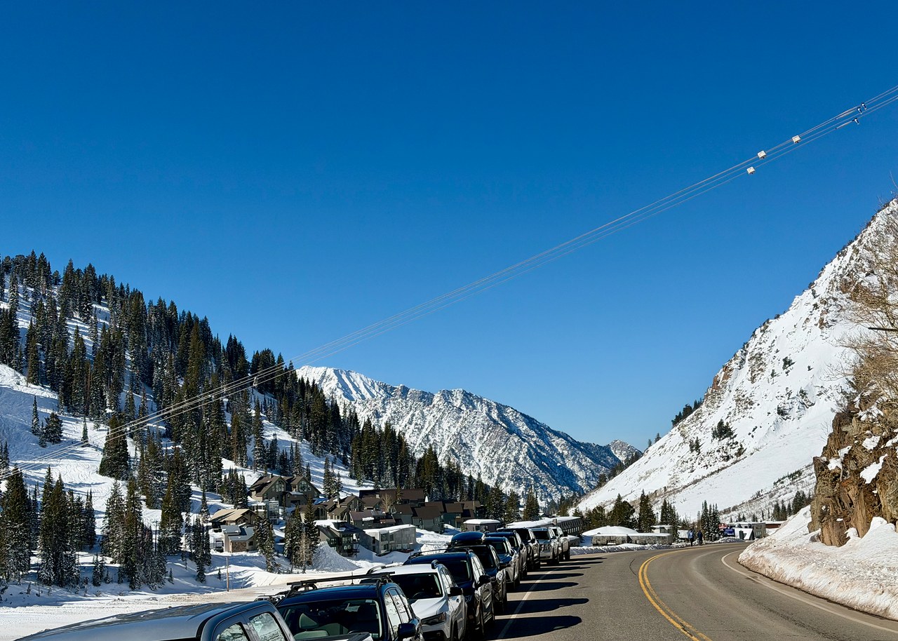 Feeder area and snowy canyon at Alta with mountain walls rising in the background