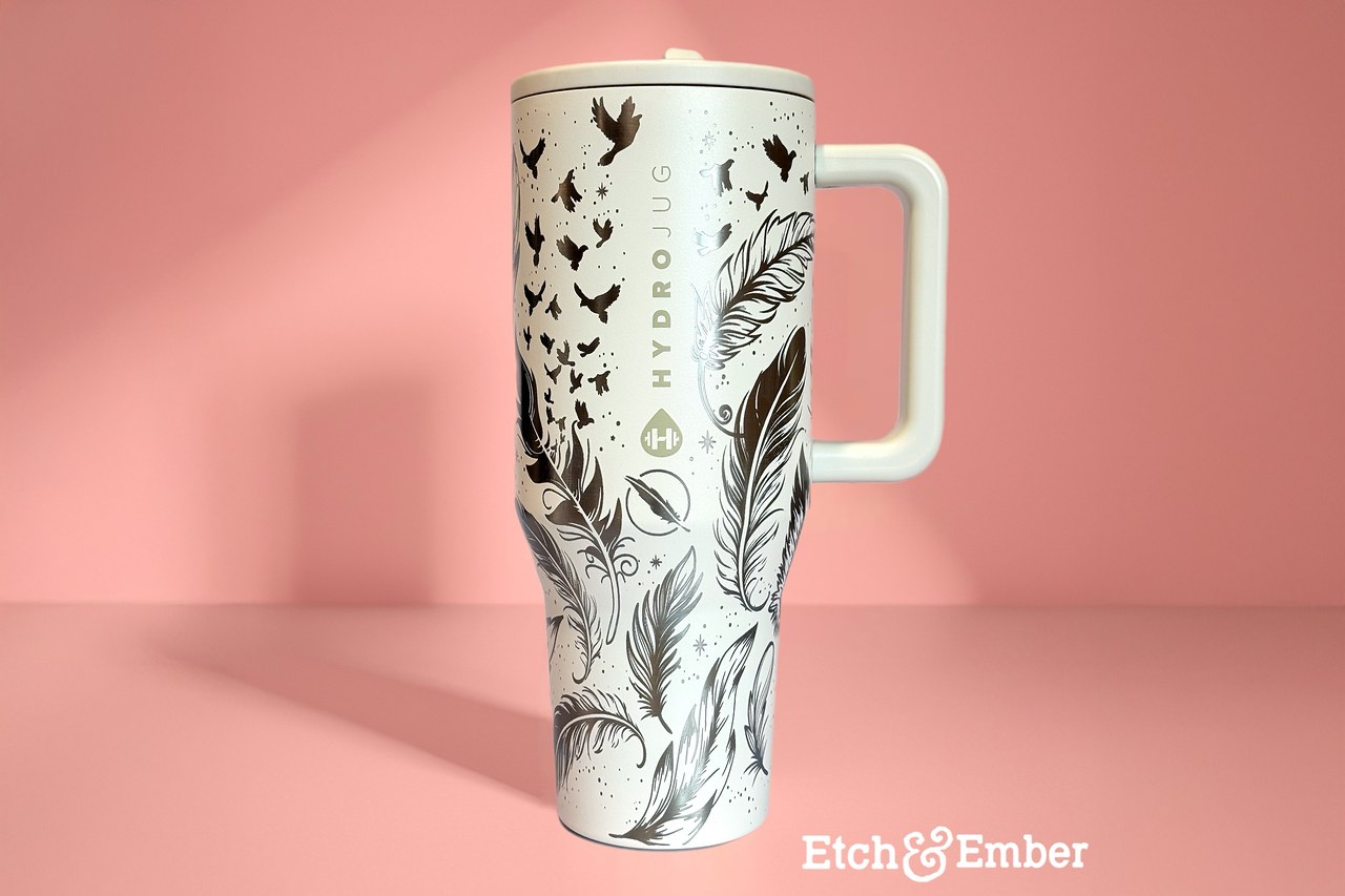 Custom decorated FeatherQuest tumbler with illustrated birds and feathers by Etch & Ember