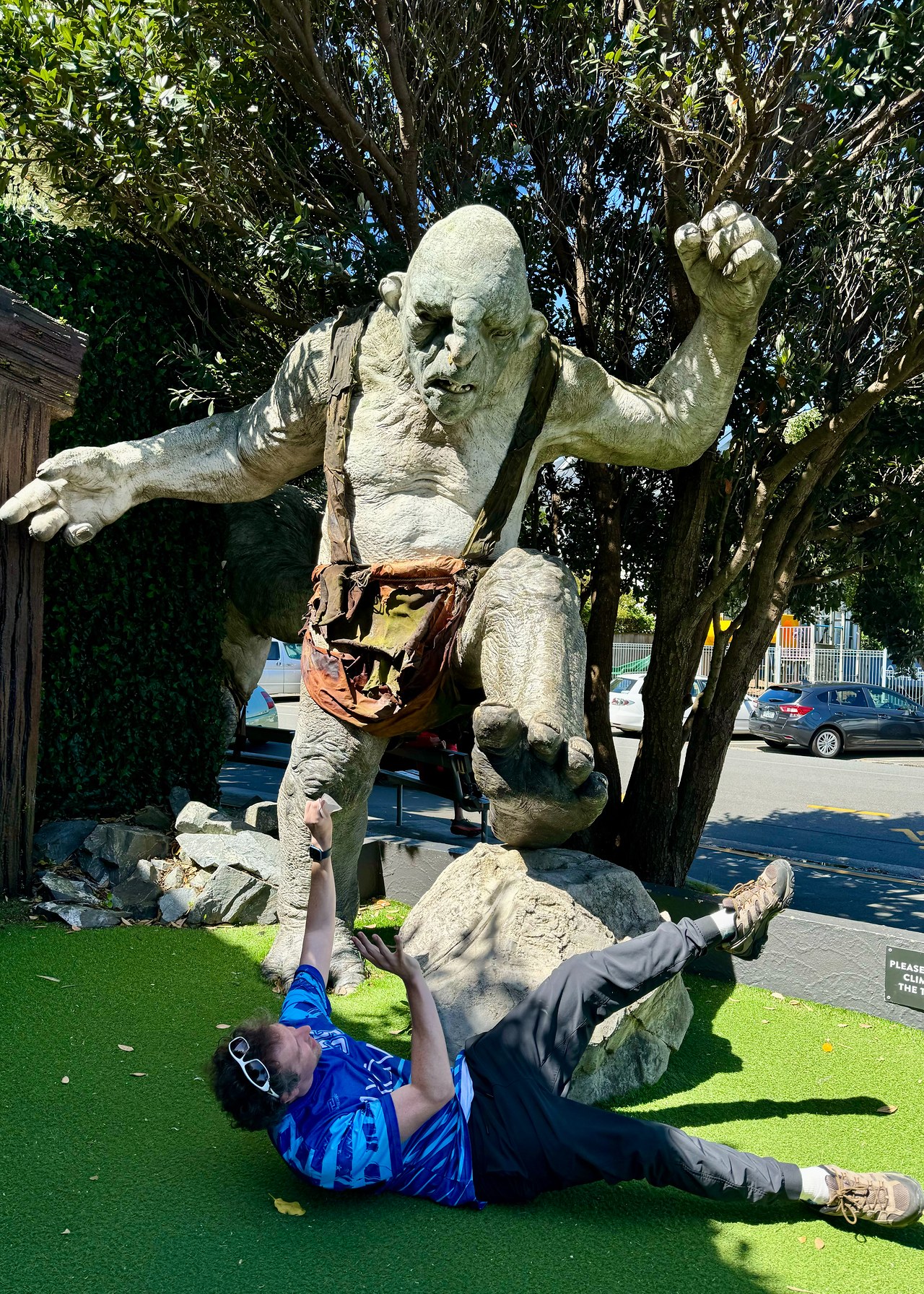 Mike pretending to fend off a giant troll statue outside Wētā Workshop in Wellington, New Zealand.