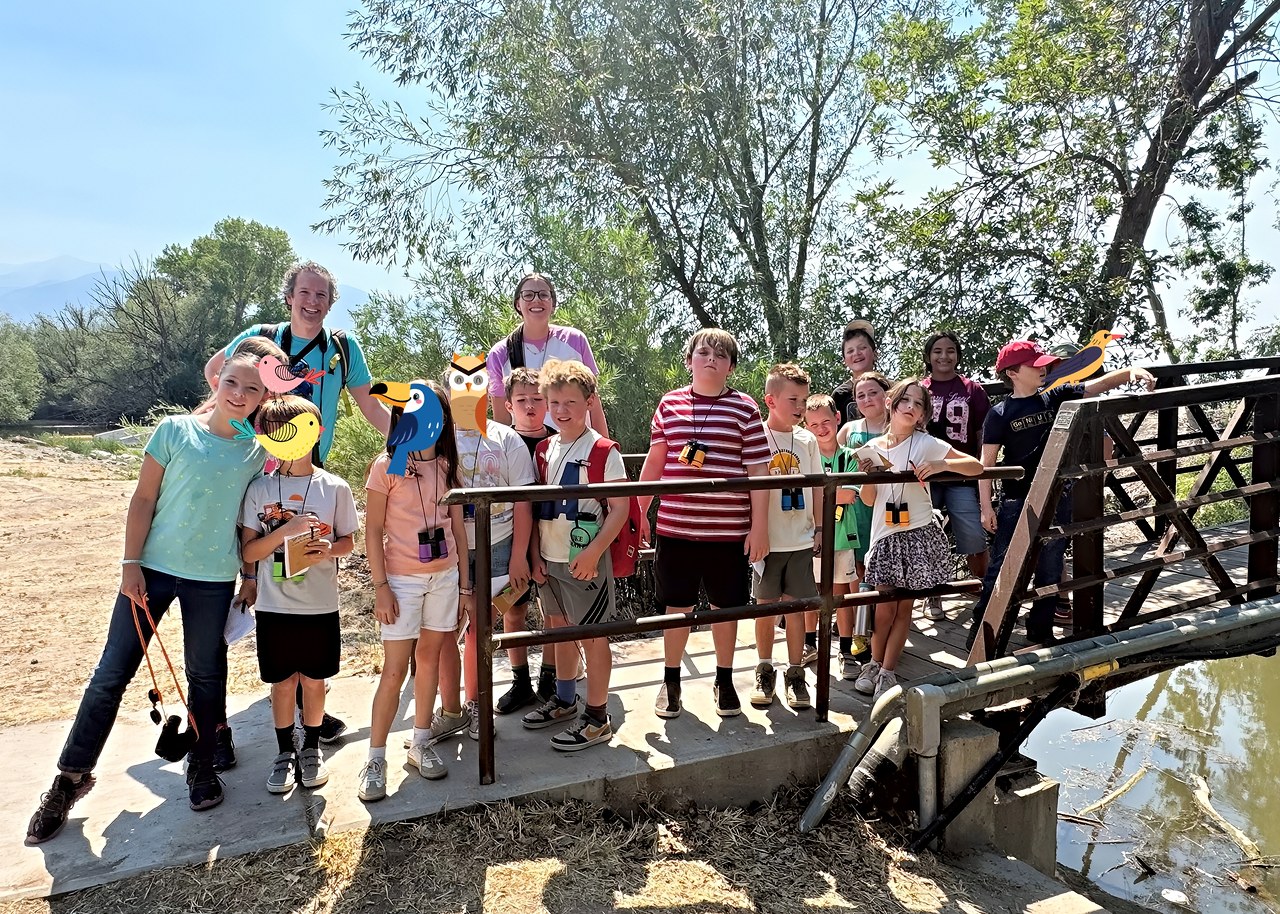 Wasatch Nature School campers and leaders gather for a group photo after a FeatherQuest bird walk at Utah Lake State Park.