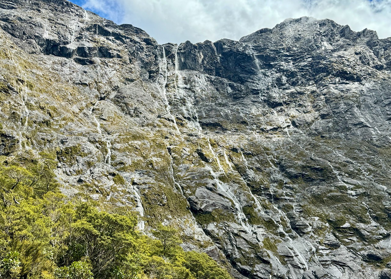 Mountain wall covered in countless tiny waterfalls in Fiordland National Park