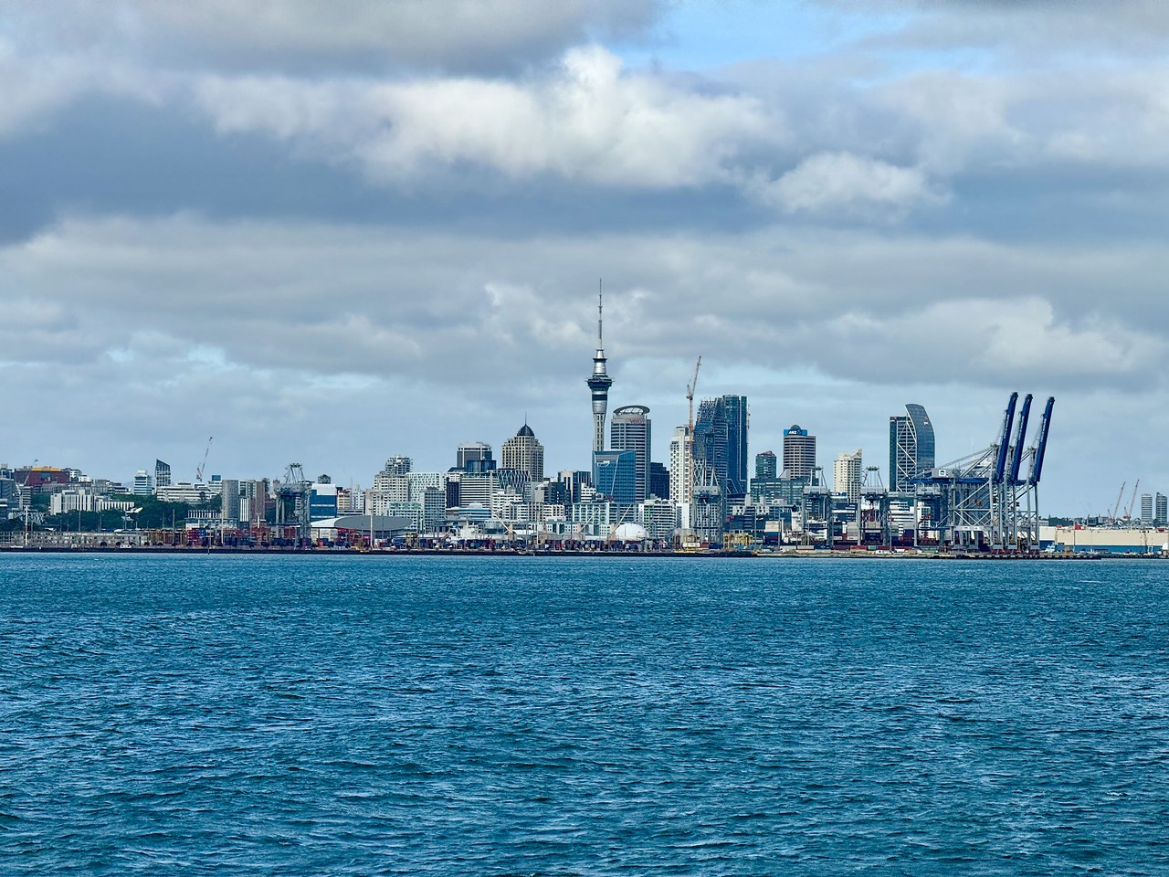Auckland skyline and harbor viewed from the ferry departing for Tiritiri Matangi Island.