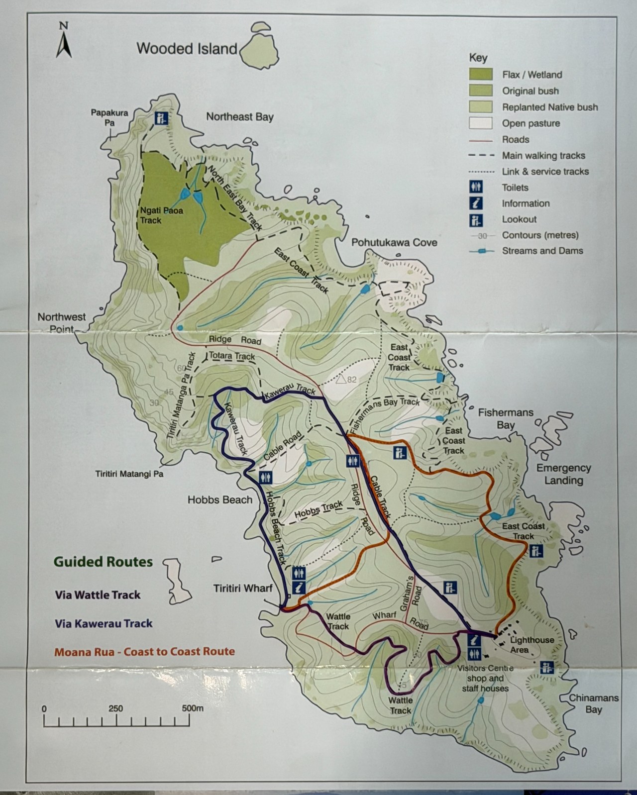Trail map of Tiritiri Matangi Island Scientific Reserve showing the island's walking tracks, coastline, lighthouse, wharf, and visitor center.