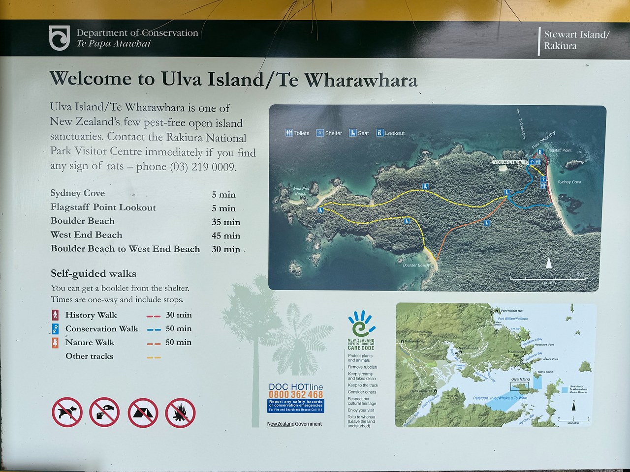 Welcome sign and trail map for Ulva Island / Te Wharawhara showing the predator-free sanctuary, walking routes, and key landmarks.