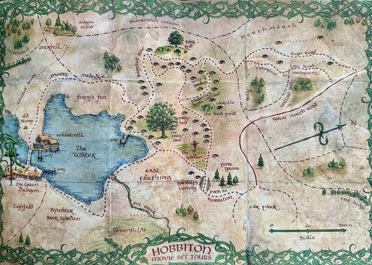 Illustrated map of the Hobbiton Movie Set showing the Green Dragon Inn, Party Tree, Watermill, Bag End, gardens, paths, and surrounding landmarks.