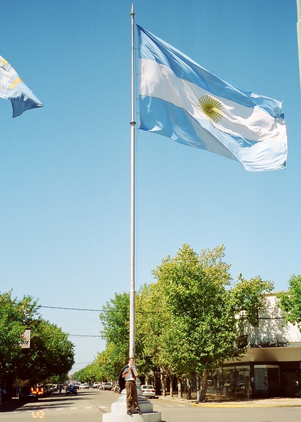 Argentine flag flying above a city street during Mike Marshall's time living in Argentina